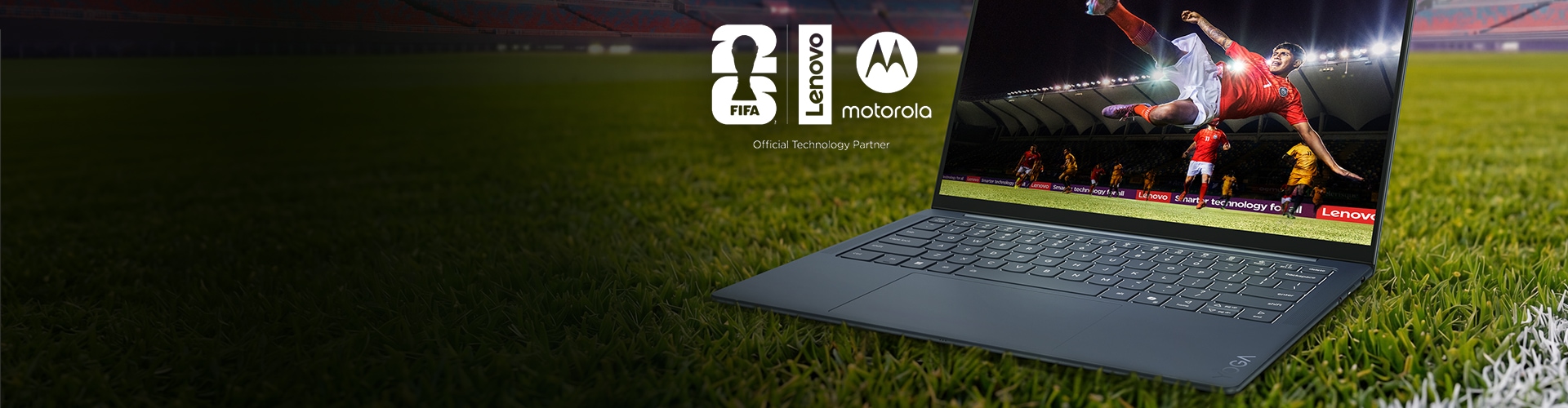 Lenovo laptop on a soccer field displaying a player mid-kick in a stadium, with FIFA, Lenovo, and Motorola logos shown as official technology partners.