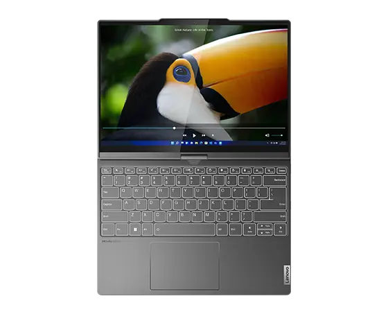 Lenovo ThinkBook Plus Gen 4 (13″ Intel) 2-in-1 laptop—view from above, lying flat with hinge open 180 degrees in notebook mode, with a close-up image of a toucan on the display