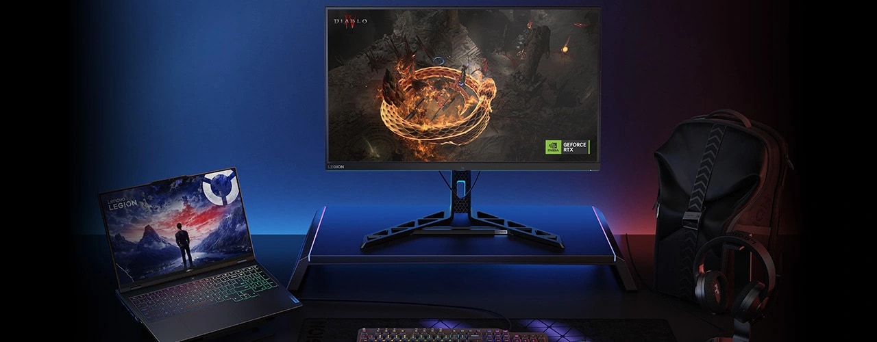 Legion Pro 7i Gen 9 on a desk connected to a Legion gaming monitor with Diablo IV on screen, with other Legion accessories around it and an NVIDIA® GeForce RTX™ badge