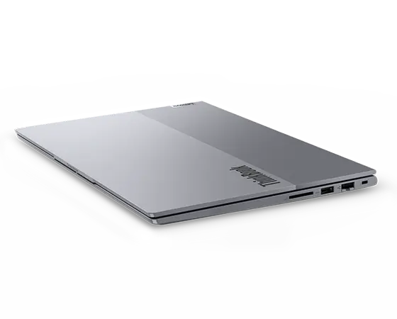 Right side, tilted view of Lenovo ThinkBook 14 Gen 7 (14 inch Intel) laptop with closed lid, focusing its top cover & four visible ports.