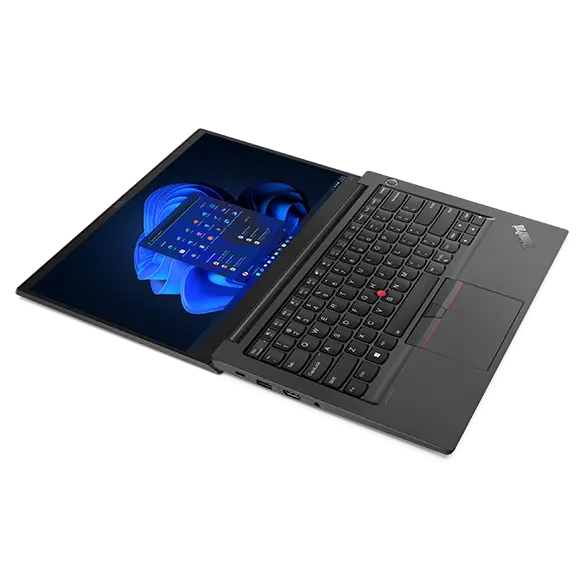 Aerial view of ThinkPad E14 Gen 4 business laptop, opened 180 degrees, flat, showing keyboard and display with Windows 11