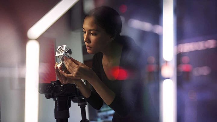 A photographer adjusting her camera equipment