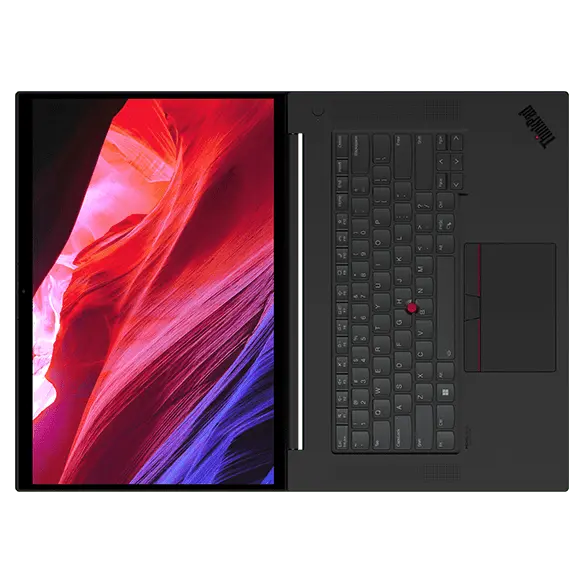 Vue aérienne de la station de travail portable Lenovo ThinkPad P1 Gen 6 (16 » Intel), ouvert à plat à 180 degrés, montrant le clavier et l’écran avec des formes rouges et bleues fluides à l’écran