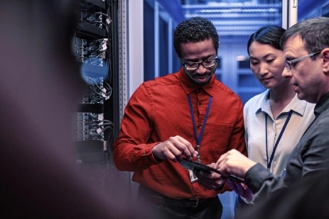 Three colleagues collaborating on servers