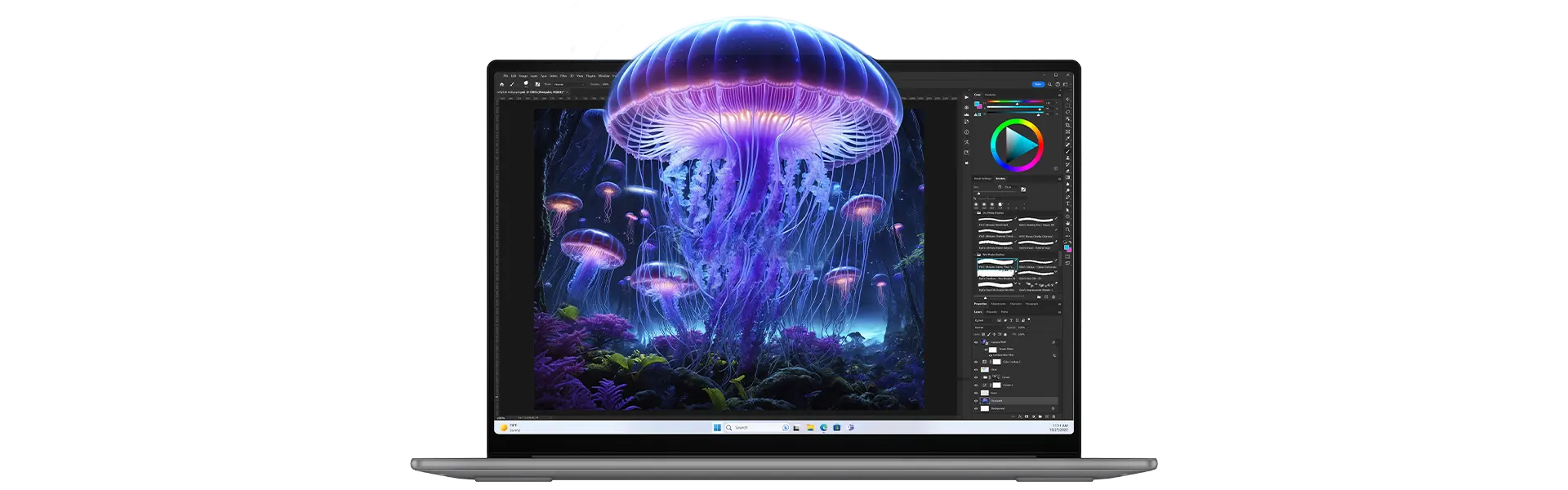 A Lenovo laptop displaying a glowing jellyfish in image editing software