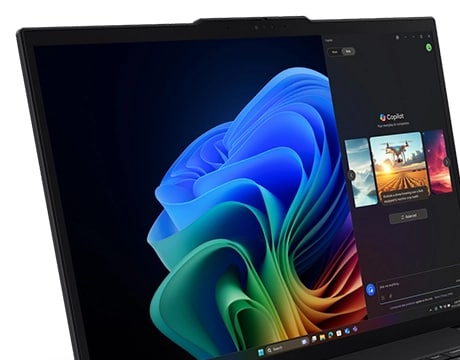 Lenovo ThinkPad T16 Gen 4 (16" Intel) laptop – close-up left-front view, lid open with Copilot menu against multicolored Windows Bloom background on the display 