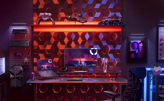 A colorful, fully-equipped gaming room featuring the Lenovo Legion Pro 7 Gen 10 (16” AMD), a monitor, a keyboard, and more. מחשב נייד Legion Pro 7 16AFR10H 83RU001RIV מבית Lenovo