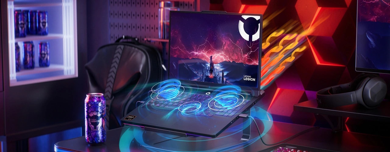 Circular blue swirls emerge from the Lenovo Legion Pro 7 Gen 10 (16” AMD), against a colorful background including a mini-fridge, keyboard, and monitor. מחשב נייד Legion Pro 7 16AFR10H 83RU001RIV מבית Lenovo