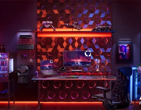 The Lenovo Legion Pro 7 Gen 10 (16” AMD) in a fully-equipped gaming room with keyboards, monitor, and other accessories. מחשב נייד Legion Pro 7 16AFR10H 83RU001RIV מבית Lenovo