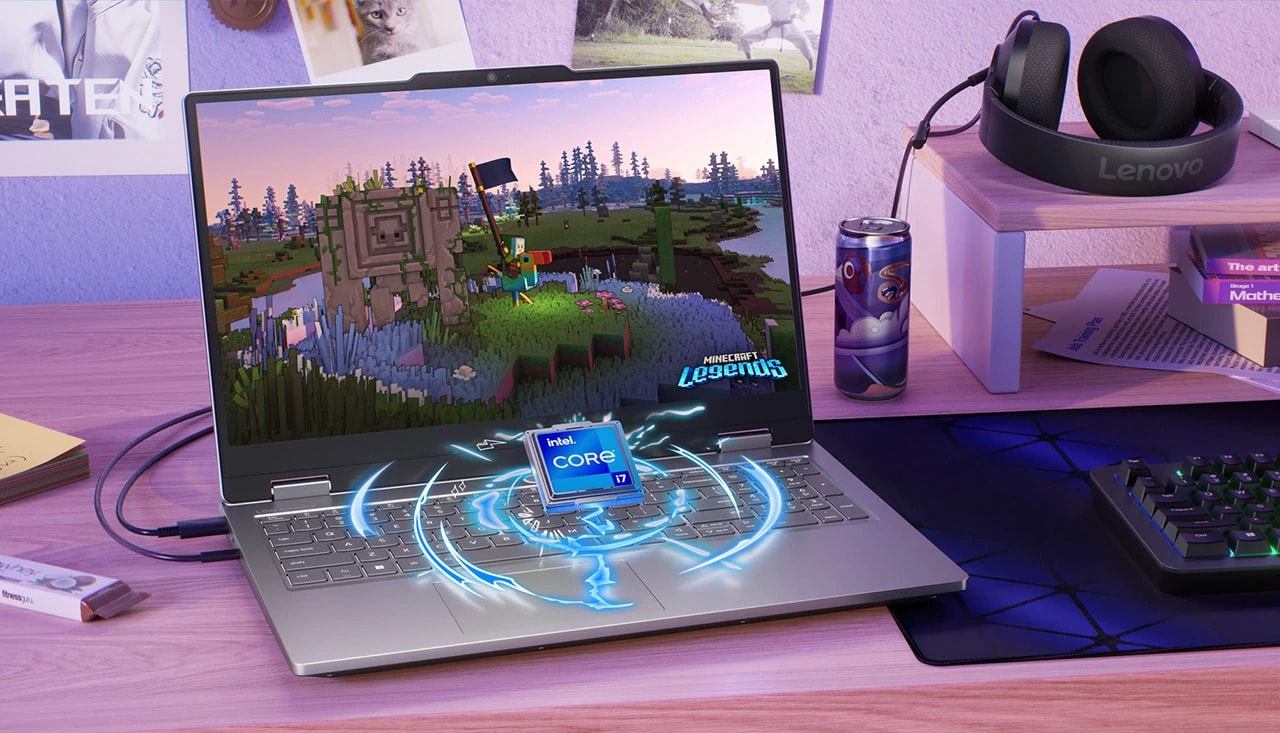 Lenovo LOQ Essential 15IRX11 gaming laptop on a desk with headset and a keyboard – front view, lid open, with Minecraft Legends screen on the display and an Intel® Core™ i7 processor chip appearing to rise out of the laptop keyboard.