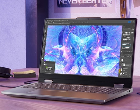 Lenovo LOQ Essential 15IRX11 gaming laptop on a desk – front view, lid open, with NVIDIA Studio screen on the display.