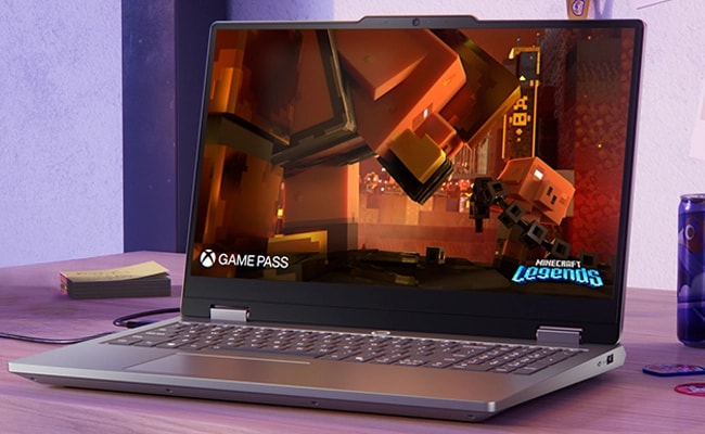 Lenovo LOQ Essential 15IRX11 gaming laptop on a desk – front view, lid open, with Minecraft Legends screen and PC Game Pass logo on the display.