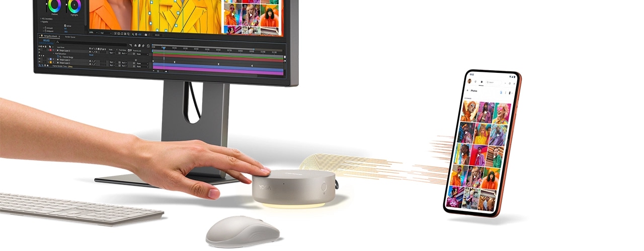 A hand interacts with a Lenovo Yoga Mini i Gen 11 (Intel) PC, connecting wirelessly to a smartphone, boasting its multisensory features & capabilities.