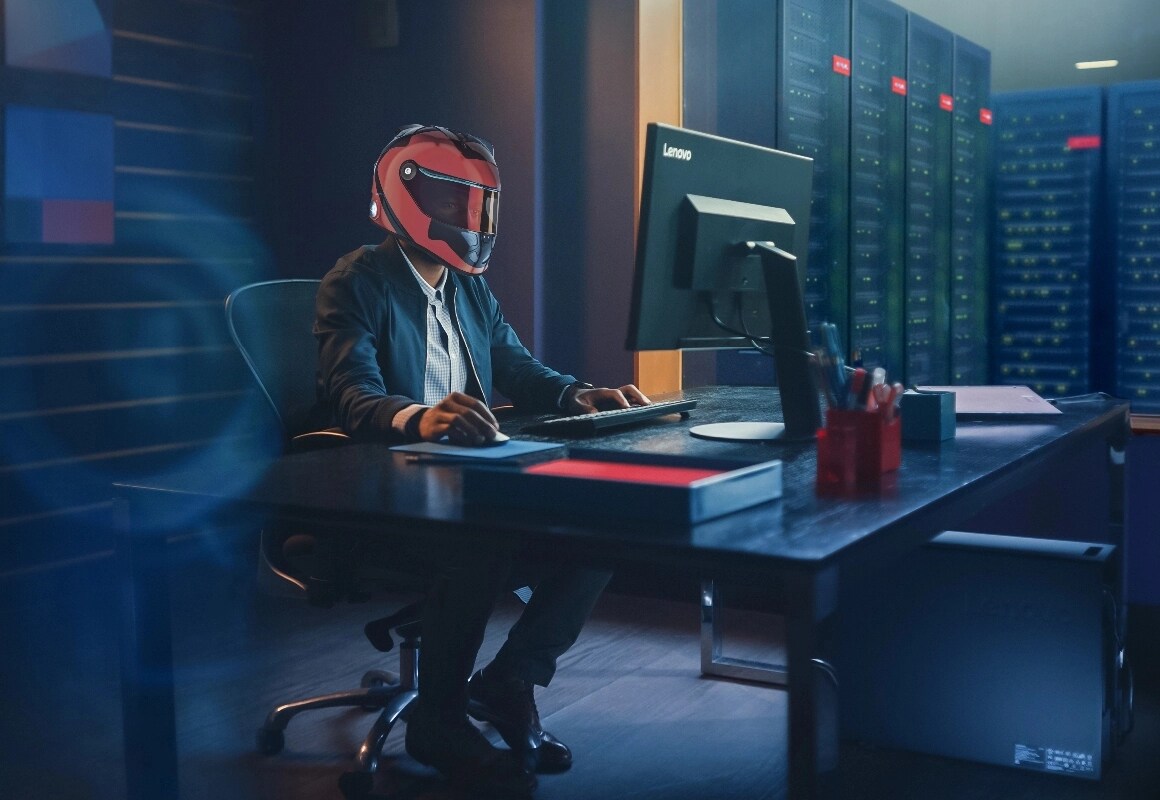 A man in a race helmet working on a ThinkStation in a data center