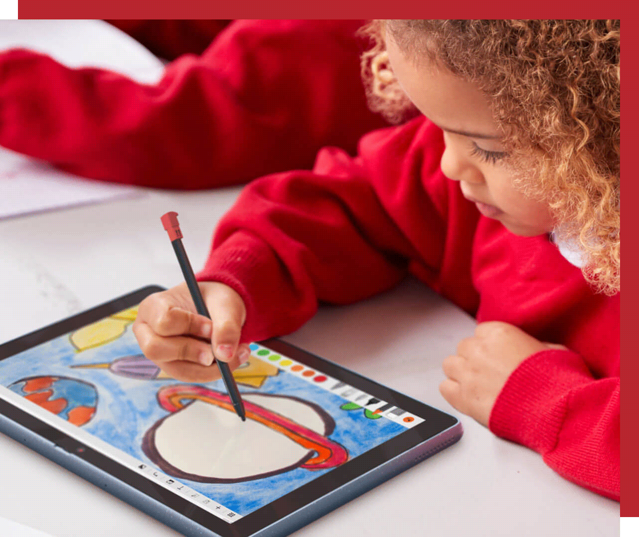 Young child using a stylus to draw on a Lenovo tablet 