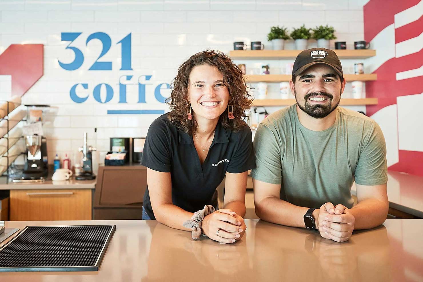 Linsay & Michael leaning on the 321 coffee counter