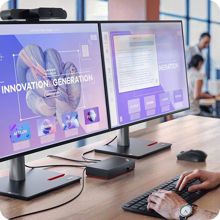  In the office, a person is working with a ThinkPad dock which connects two monitors. 