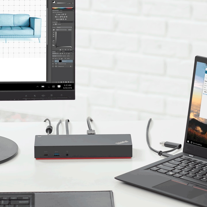 A ThinkPad dock connects a laptop, monitor, and keyboard. 