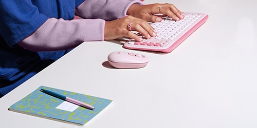  A Logitech keyboard and Mouse are featured on a desk.