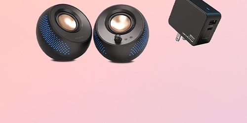 A pair of Pebble X 2.0 speakers and an adapter are featured on a background.