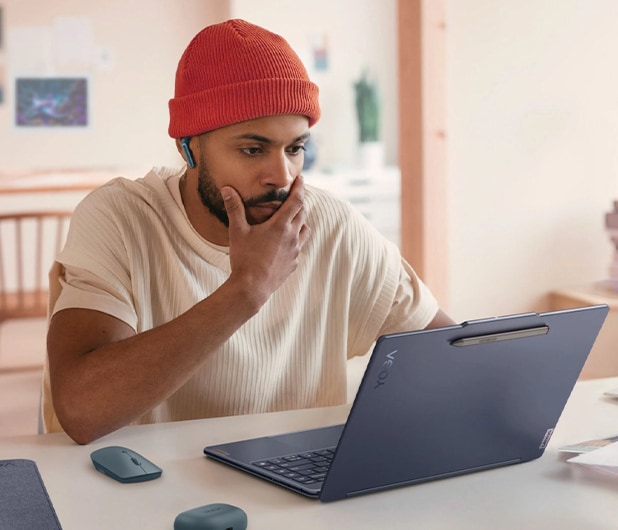 A man using his lenovo laptop to write on the go