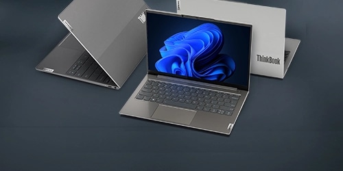 A sleek, modern laptop with a thin design is displayed in the image. There is also a a closed laptop and a box labeled 