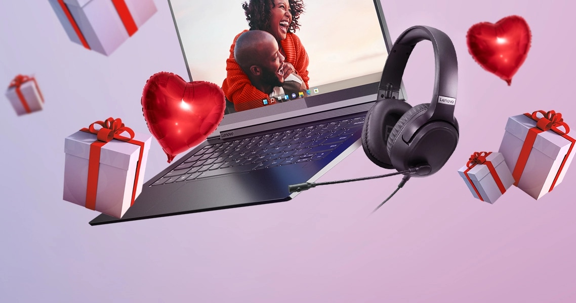 Floating open laptop, heart shaped balloons, and present