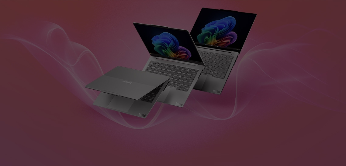 Three silver Lenovo ThinkBook laptops displayed at different angles against a pink gradient background, showcasing the slim design, keyboard, and vibrant colorful displays.