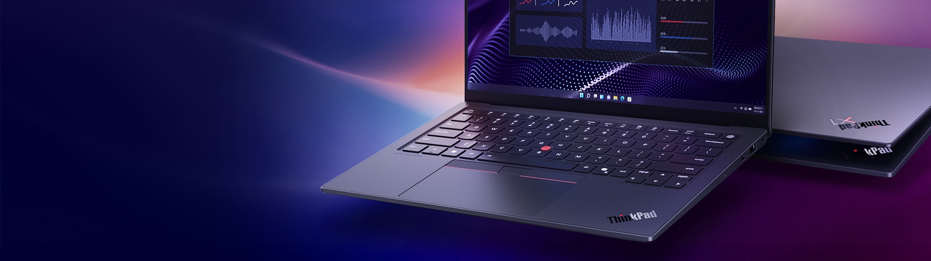 Two Lenovo ThinkPad laptops displayed against a vibrant gradient background, with the front laptop open showing data analytics graphs on screen, and a second laptop positioned behind it, highlighting a sleek, modern design.