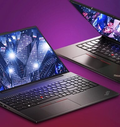 Two sleek Lenovo ThinkPad laptops partially open, showcasing bright, futuristic visuals on their screens against a vibrant purple background.