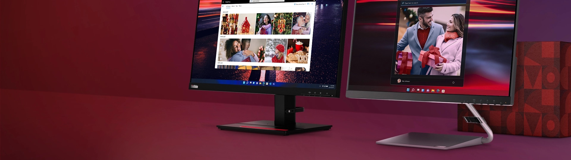 2 monitors with family screenfills next to a red gift box.
