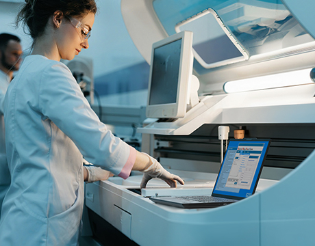 Scientist in a lab using the Lenovo ThinkPad P14s Gen 7 14" AMD) laptop for complex data analysis.