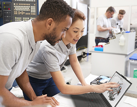 Two engineers discussing a 3D model displayed on the Lenovo ThinkPad P14s Gen 7 (14" AMD) laptop.