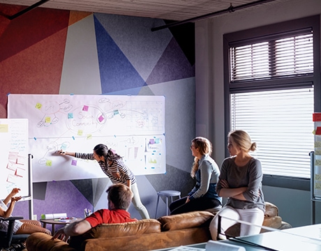 Team brainstorming about a project, supported by the Lenovo ThinkStation P4 (AMD) Tower Workstation.