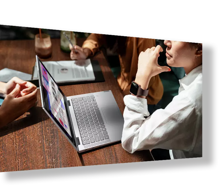Group of people in a cafe, with Lenovo laptop opened and drinks on table