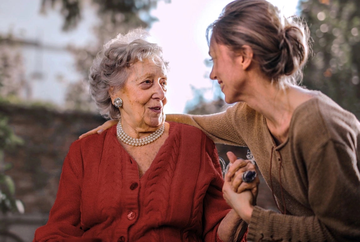 A young woman and an elderly woman talking