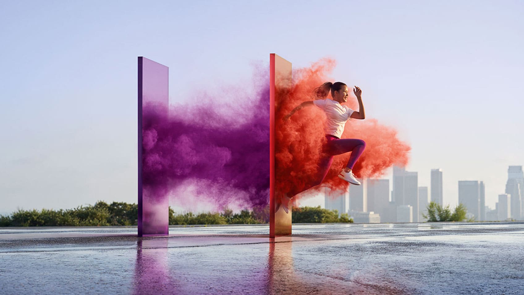 A woman bursting through a purple and red panel with a city skyline in the background