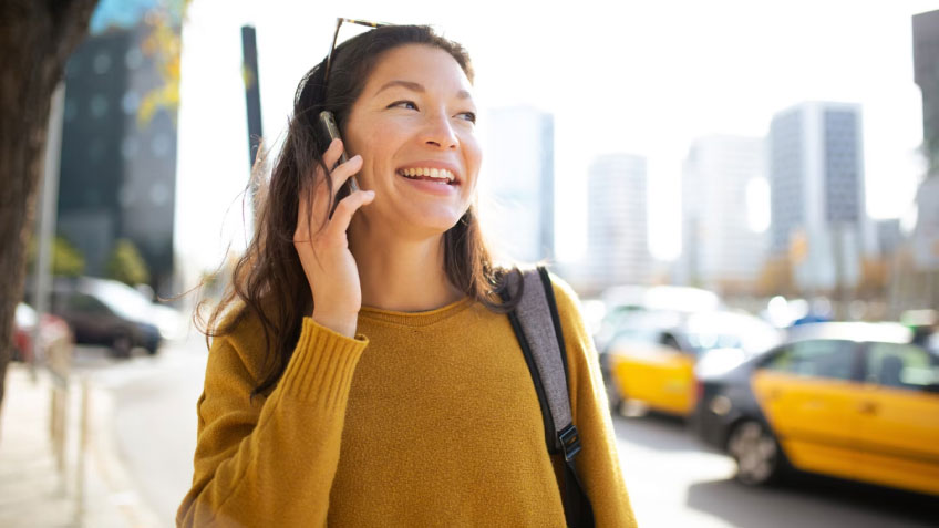 A woman talking outside on a cell phone