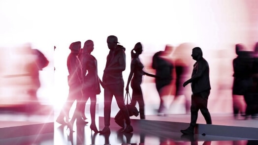 Silhouettes of people in front of a bright light