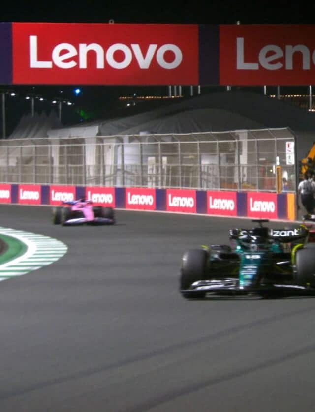 Formula 1 cars mid-race with Lenovo banners along the track