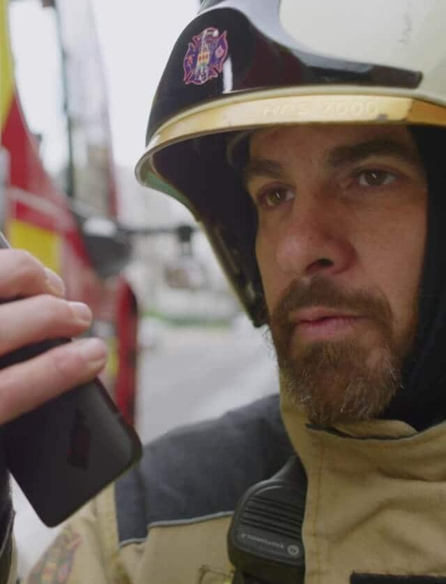 A firefighter using a walkie talkie