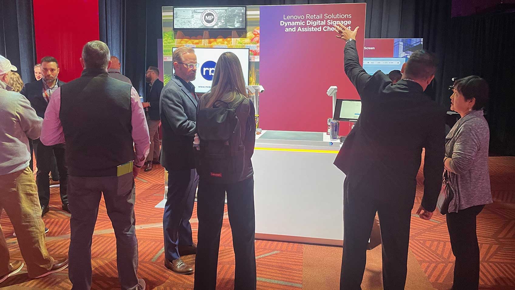 Visitantes del stand de Lenovo en Tech World en los Estados Unidos informándose sobre Lenovo Retail Solutions. 