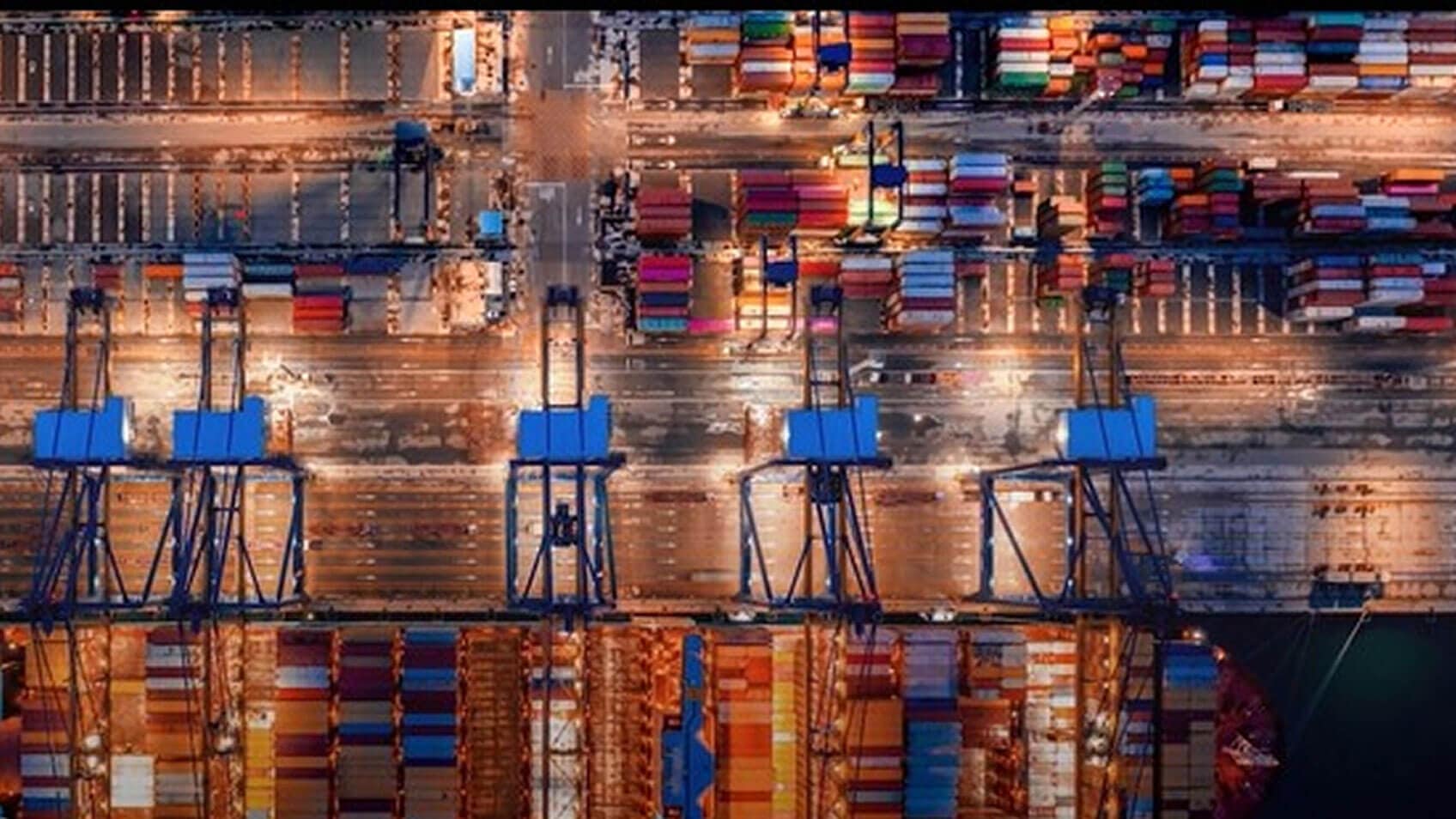 An aerial shot of a container yard and the large cranes that move them. 