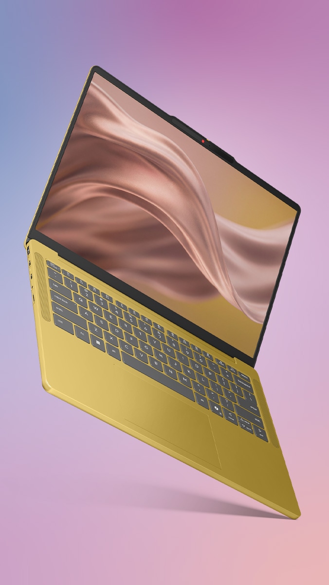 Una laptop Lenovo IdeaPad Vibe en color dorado especiado que parece flotar en el aire con la tapa abierta, mostrando pintura dorada ondulada en la pantalla. 