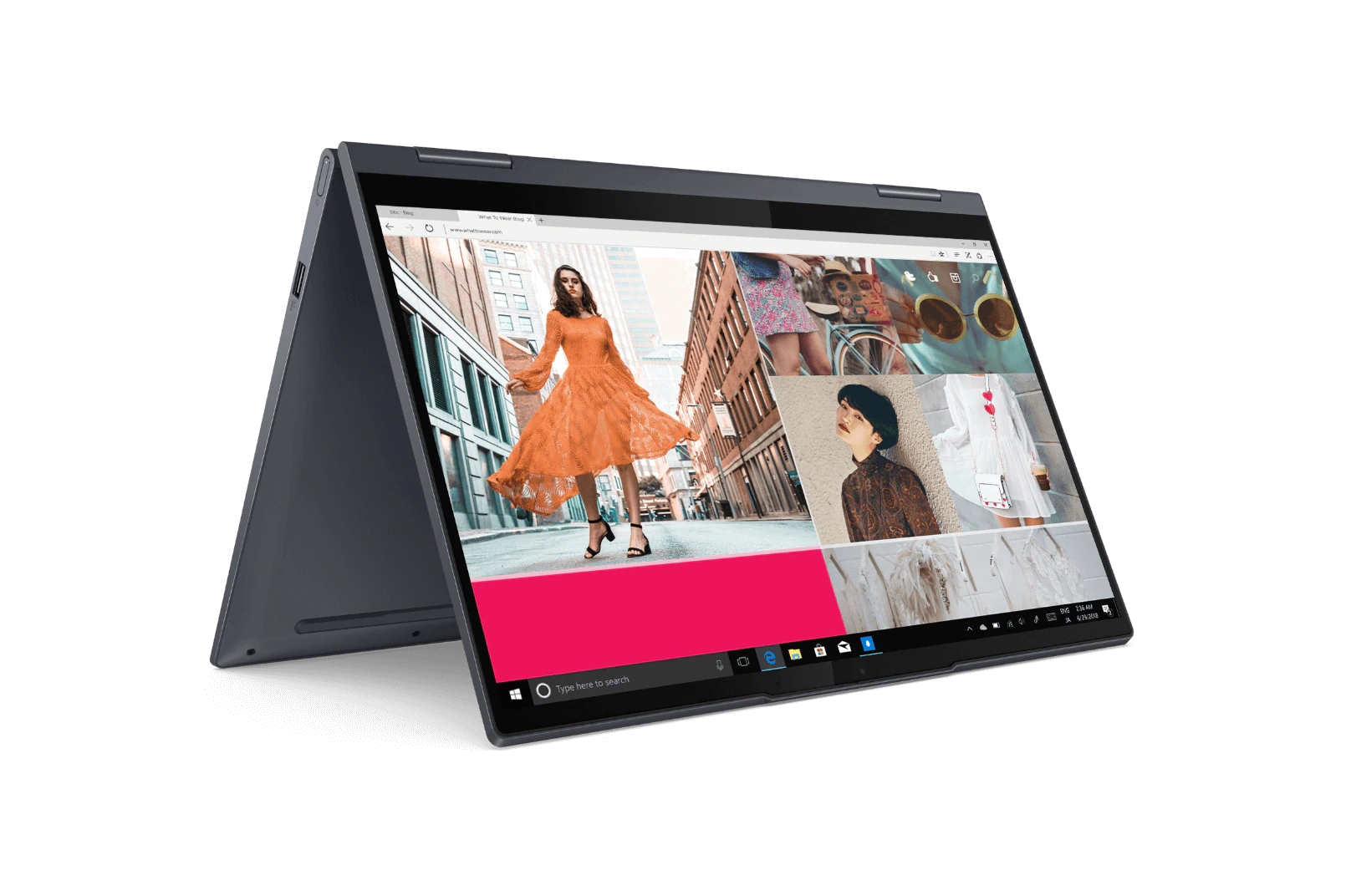 Lenovo Yoga 2-in-a laptop left three-quarter view in tent mode, displaying fashion web page on screen.