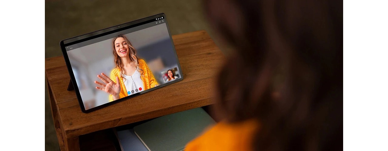 ¾ front view of two hands holding Lenovo Tab P11 tablet horizontally during video call