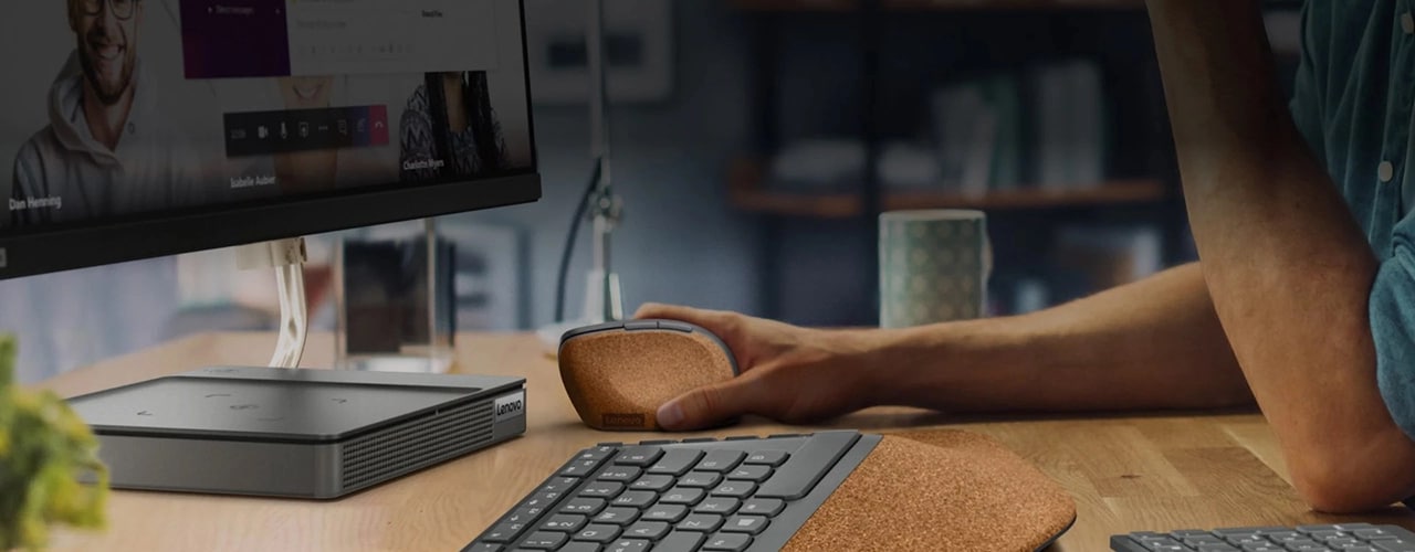 Lenovo Go Wireless Split Keyboard on desk with Lenovo Go Wireless Vertical mouse with user.