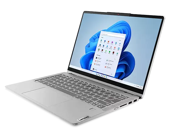 Front-right angle view of the 14” IdeaPad Flex 5i in laptop mode, showing the keyboard, touchpad, right-side ports, and display, which depicts an OS panel against a swirling blue shape