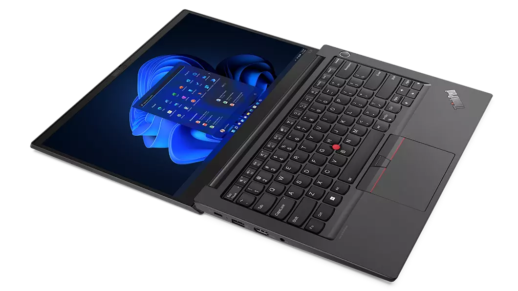 Aerial view of ThinkPad E14 Gen 4 business laptop, opened 180 degrees, flat, showing keyboard and display with Windows 11