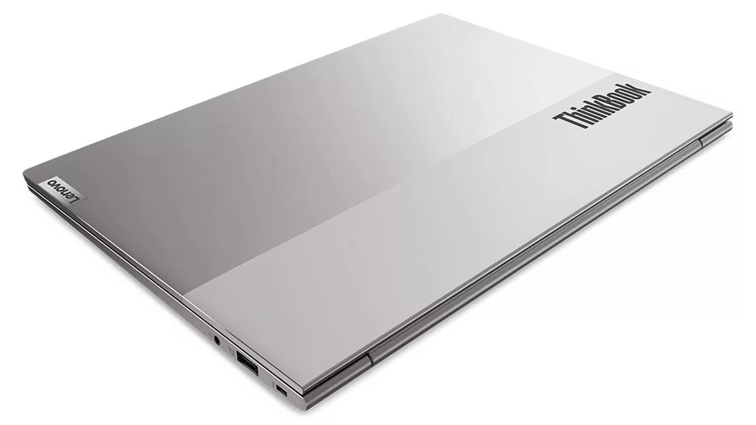 Closed, dual-tone book-like cover on the Lenovo ThinkBook 13s Gen 4 laptop in Cloud Grey, angled to show left front corner with side ports.